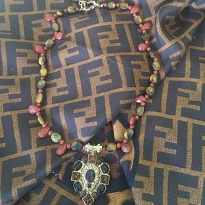 2 gold/bronze/brown costume jewelry necklaces.